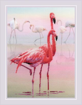 A cross-stitch design featuring two vibrant pink flamingos standing in shallow water with more flamingos in the soft pastel background.