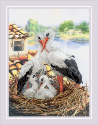 A cross-stitch design of two adult storks and three chicks nestled in a straw nest near a lakeside cottage.