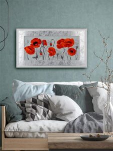 A cross-stitch design of vivid red and orange poppies with black centers, standing tall against a soft background with faint floral sketches.