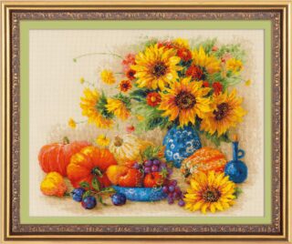 Cross-stitch design of a rustic autumn still life with pumpkins, gourds, grapes, plums, and a vibrant bouquet of sunflowers in a blue vase.
