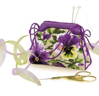 Cross-stitch pincushion shaped like a small handbag, decorated with purple and yellow pansy flowers. Purple cord handles and green ribbon accents complete the design. Includes pins and gold embroidery scissors. Design from RIOLIS kit 1039.