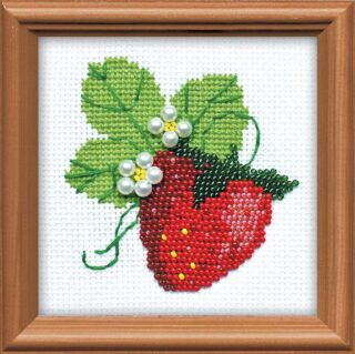 Cross stitch with beads on a bright red strawberry with green leaves and white pearl-like beaded flowers on white fabric.