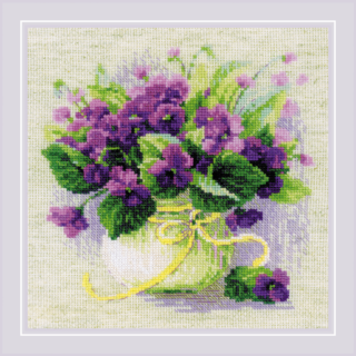 A white pot filled with vibrant purple violets and lush green leaves, tied with a soft yellow ribbon.