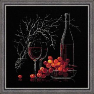 Cross stitch of a wine bottle, two glasses of red wine, and a bowl of red grapes with bare tree branches in the background on a black canvas.