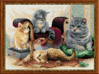 Cross-stitch embroidery of a cat family. A large grey cat rests on a green cushion while three playful kittens sit and lounge around antique furniture. Design from RIOLIS kit 1327 Feline Family.