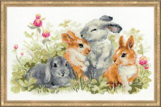 Cross-stitched image of four cute rabbits—two gray and two brown—sitting among green grass and pink clover flowers.