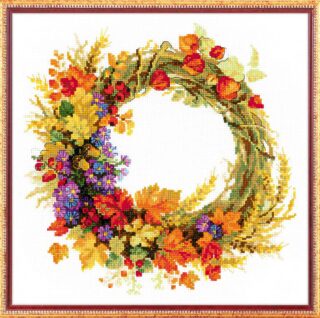 Cross-stitched autumn wreath with golden wheat, bright red berries, orange leaves, and colorful wildflowers, stitched on white fabric.