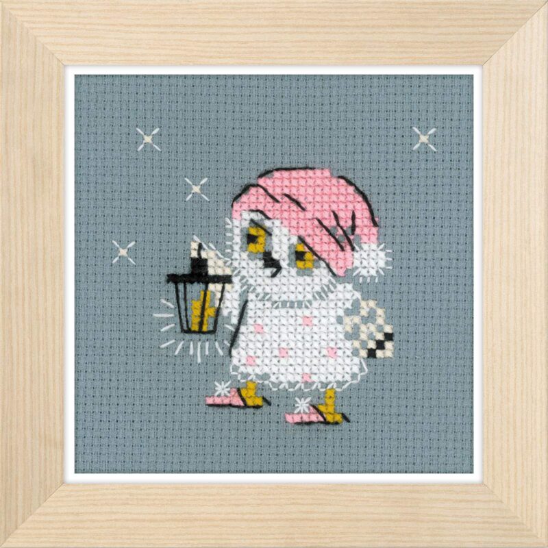 Cross-stitched owl in pink pajamas and nightcap holding a glowing lantern, stitched on gray fabric with stars in the background.