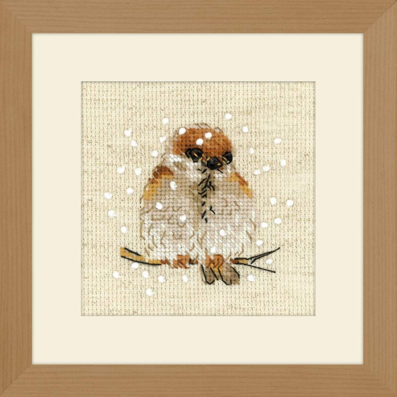 Cross stitch design of a small brown sparrow sitting on a branch with snowflakes falling around it.