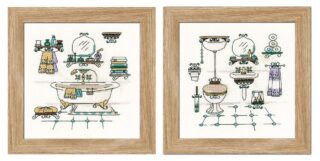 Cross-stitched bathroom scene with vintage fixtures, towels, shelves, and accessories in soft pastel shades, shown in two framed panels.