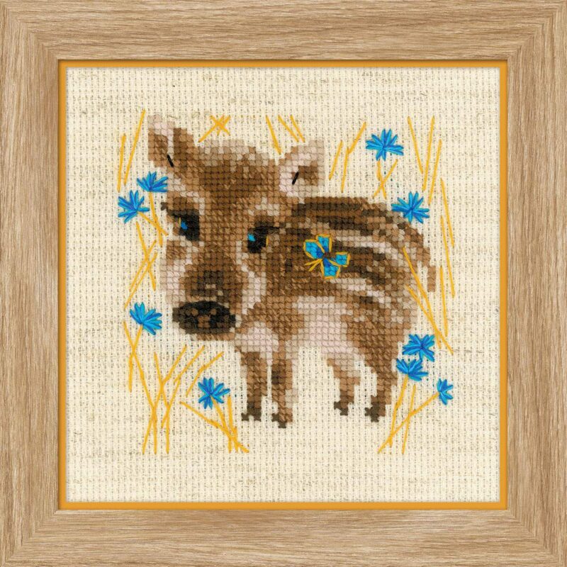Cross-stitch image of a baby wild boar standing in golden grass with bright blue flowers.
