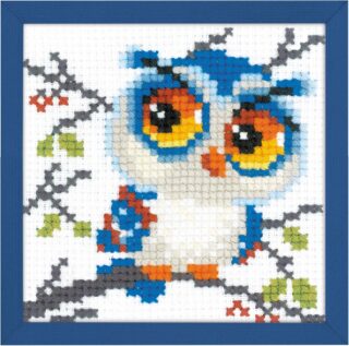 Cross-stitched design of a wide-eyed blue and white scops owl perched on a branch with green leaves and orange details.