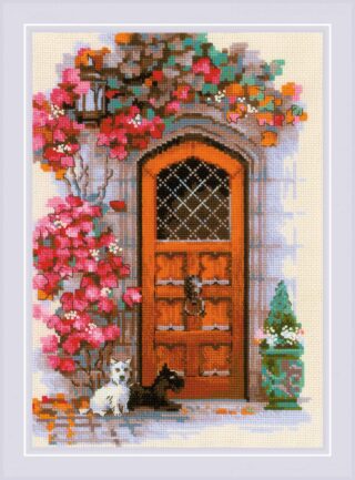 A warm wooden door framed by climbing pink flowers with two small dogs sitting at the entrance.