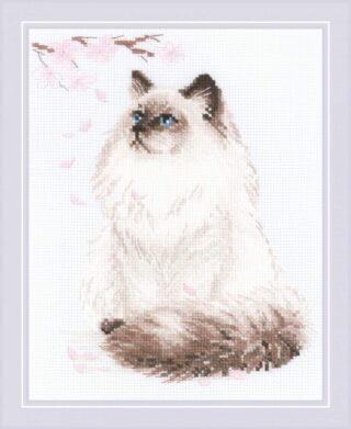 A cross stitch of a fluffy cat with blue eyes sitting calmly under falling cherry blossoms.