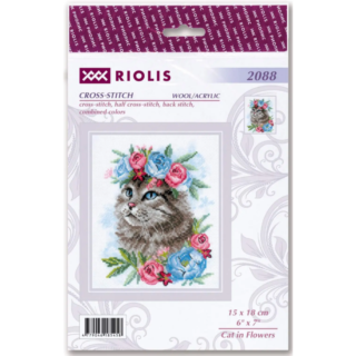 Cross-stitch design of a fluffy gray cat with blue eyes surrounded by pink and blue flowers.
