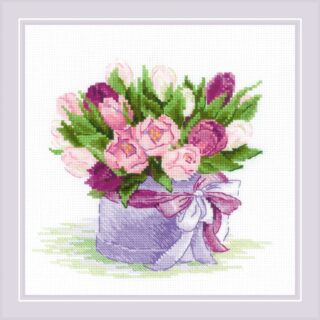 A bouquet of pink and purple tulips and roses arranged in a lavender hat box tied with a large ribbon.