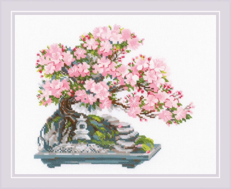 A delicate cross stitch design of a flowering bonsai tree with soft pink blossoms growing from a rocky base in a decorative tray.