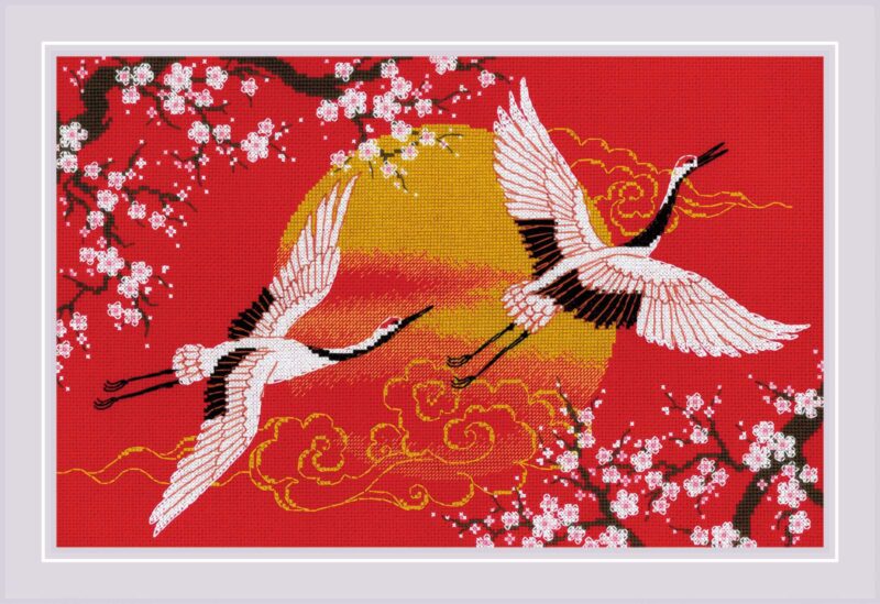 An elegant cross stitch design of two cranes flying against a red background with a golden sun, cherry blossoms, and decorative clouds.