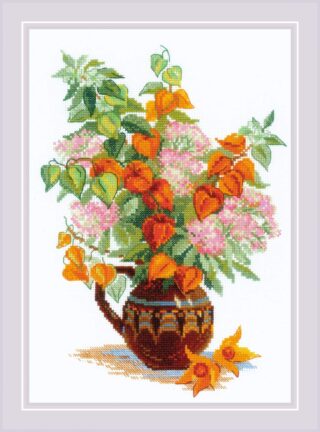 A beautiful cross stitch bouquet of orange physalis lantern flowers and soft pink blossoms arranged in a decorative brown ceramic jug.