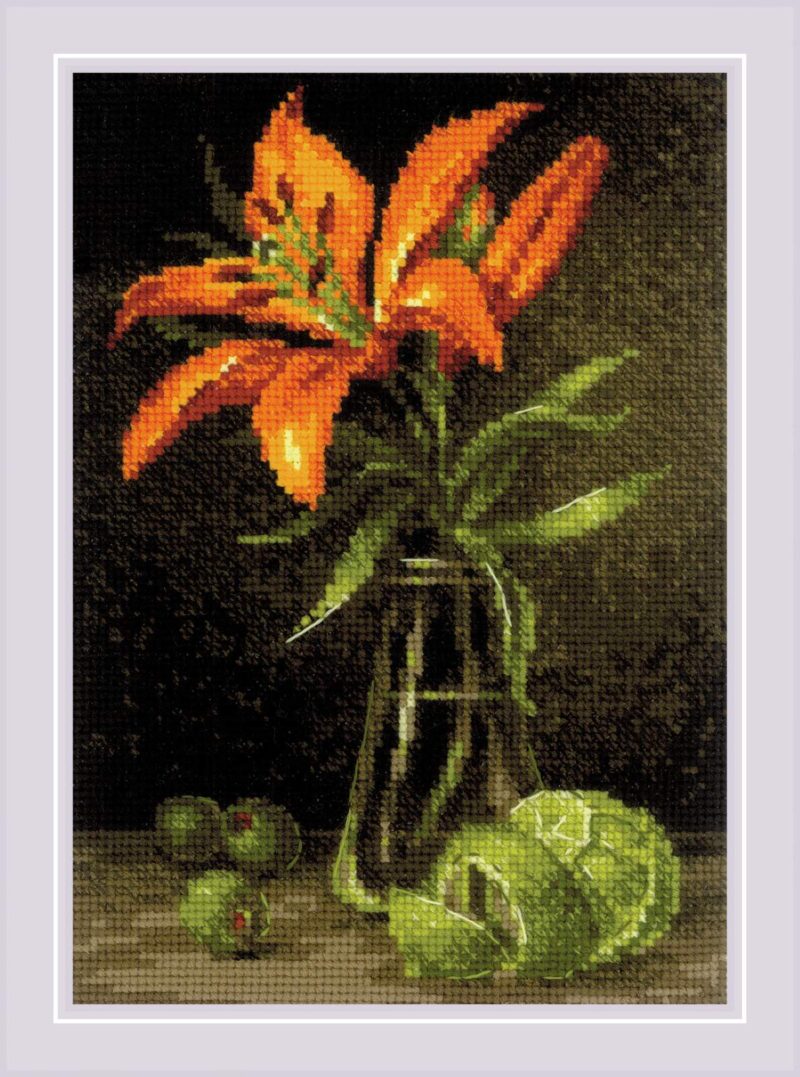 A vivid orange lily in a glass vase with fresh green limes on a dark background.