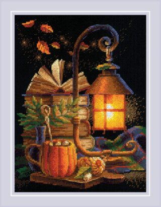 Cross-stitch design of a glowing lantern on a wooden table with books, a pumpkin mug, autumn leaves, and cozy fall accents.