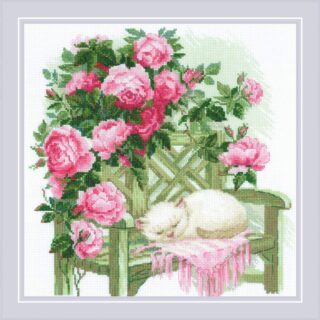 White kitten sleeping peacefully on a green garden bench surrounded by blooming pink roses.