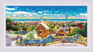 A cross-stitch design of Barcelona’s colorful Park Güell featuring mosaic-tiled terraces, whimsical architecture, and a panoramic city view under a bright blue sky.