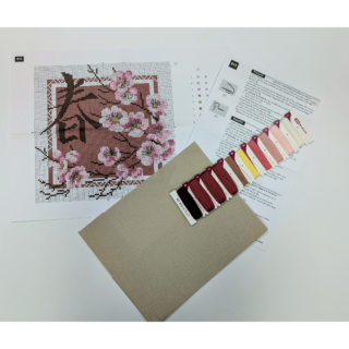 A cross-stitch design of blooming cherry blossoms in soft pink and white shades, framing a decorative square with an Asian-inspired spring character.