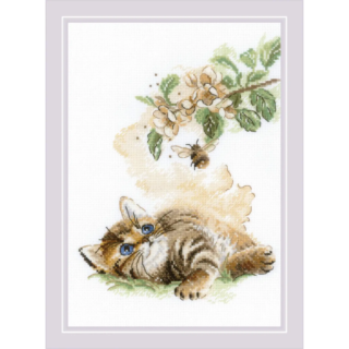 A cross-stitch of a kitten lying in grass and gazing at a flying bumblebee near a blooming branch with soft yellow and green tones.