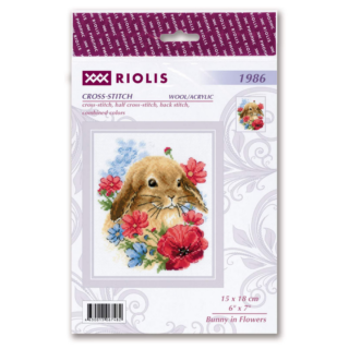 A sweet brown bunny surrounded by red, pink, and blue flowers in a cheerful cross-stitch design.