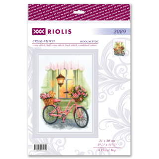 A pink bicycle with baskets of pink roses and fresh baguettes, parked by a green storefront under a warm glowing lantern.