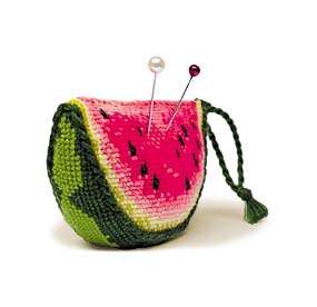 Cross-stitch design of a watermelon-shaped pincushion with pink flesh, green rind, and black seed details.