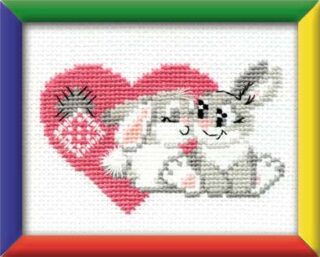 Cross-stitch of two cuddling bunnies in front of a pink heart, stitched in soft gray and white tones with colorful frame accents.