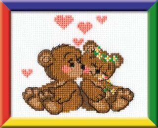 Two cute teddy bears sharing a kiss with pink hearts floating above them in a sweet cross-stitch design.