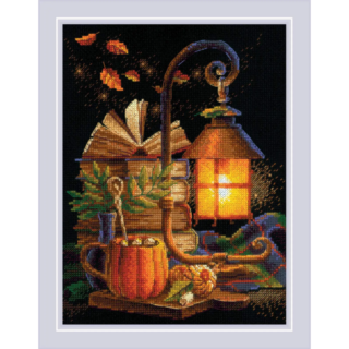 Cross-stitch design of a glowing lantern on a wooden table with books, a pumpkin mug, autumn leaves, and cozy fall accents.