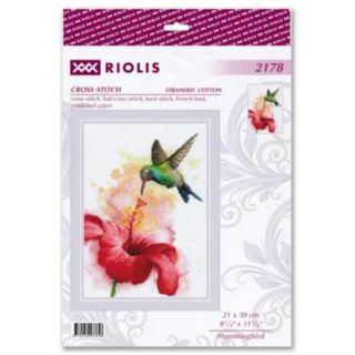 Cross-stitch design of a vibrant green hummingbird hovering near a large red hibiscus flower on a watercolor-style background.
