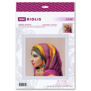 A cross-stitch design of a Middle Eastern woman in a vibrant pink and gold headscarf, adorned with blue and gold jewelry, gazing to the side.