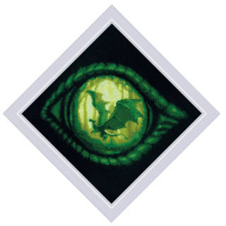 Close-up of a green dragon’s eye with a dragon silhouette in its glowing pupil, stitched on black fabric.