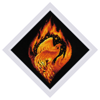 A fiery phoenix rising from bright orange flames against a black background in the 2259 Flaming Phoenix Cross-Stitch Kit from RIOLIS.