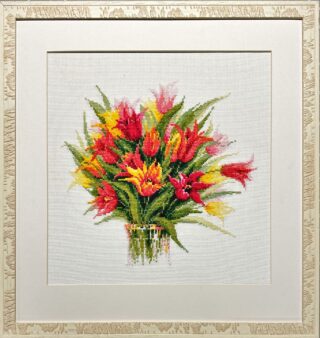Framed embroidery of a vibrant bouquet of red, yellow, and orange tulips with green leaves.