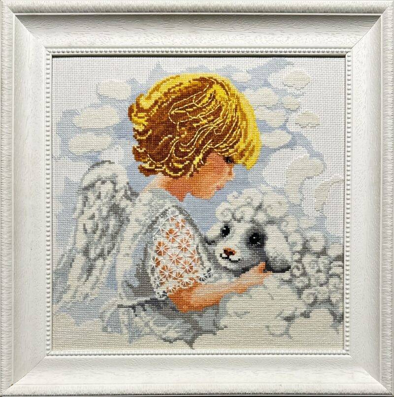 Framed embroidery of a golden-haired angel holding a white lamb among clouds with soft pastel tones.