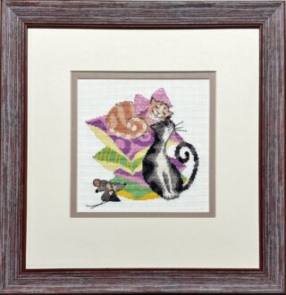 Framed embroidery of two cats resting on colorful pillows with a small mouse nearby, stitched in bright and playful colors.