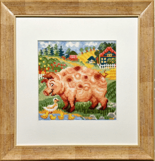 Framed embroidery of a pink pig beside a pond with ducks and ducklings in a colorful farmyard scene.