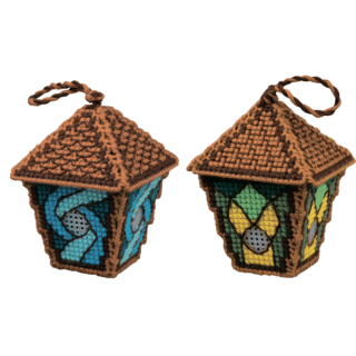 Two 3D cross-stitched lantern ornaments with stained-glass style panels in green, yellow, and shades of blue, crafted on plastic canvas.