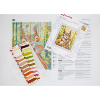 A cheerful cross-stitch design of a wide-eyed squirrel clutching an acorn with joy in a sunlit forest.