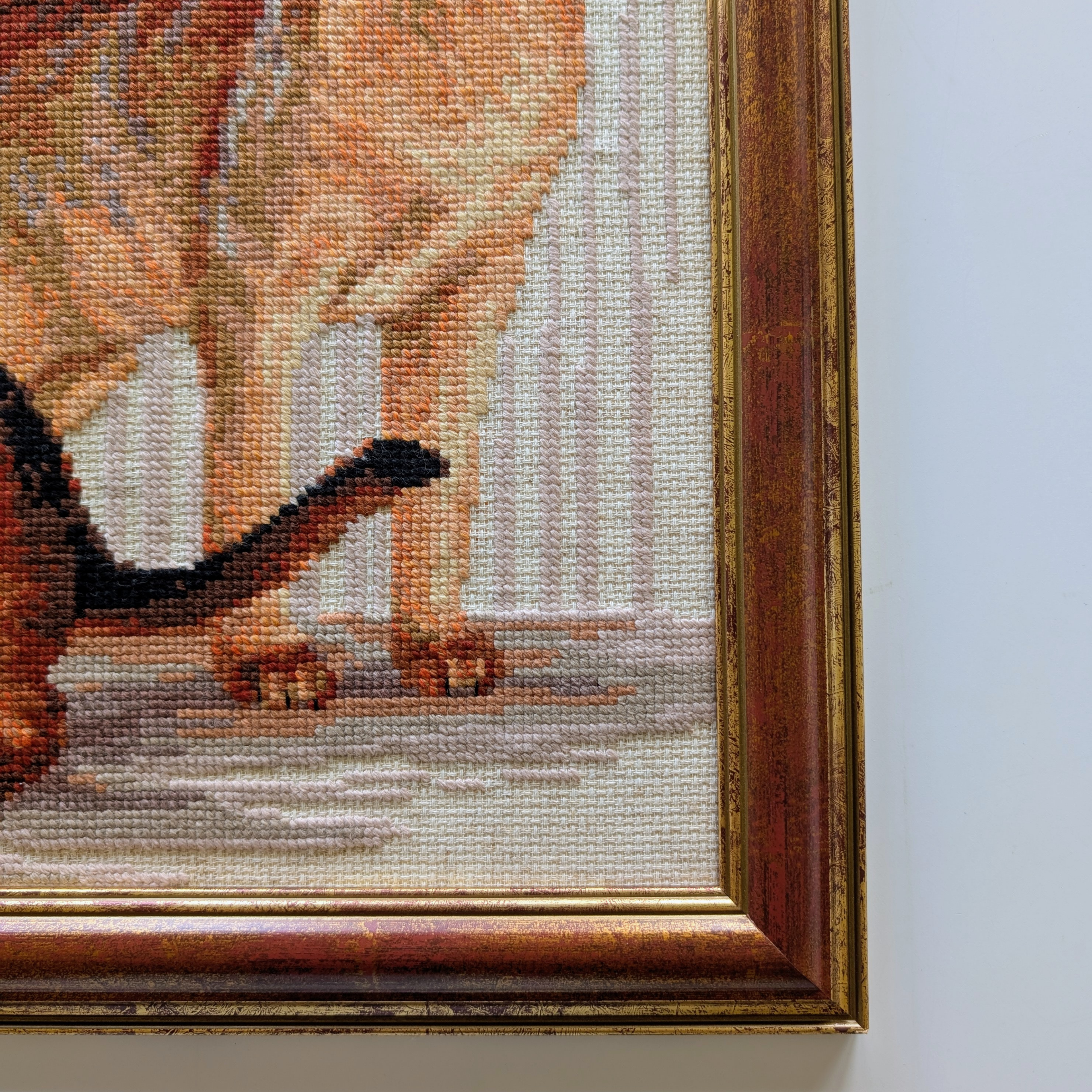 Framed cross-stitch artwork showing two Abyssinian cats posed against a background with Egyptian-style patterns.