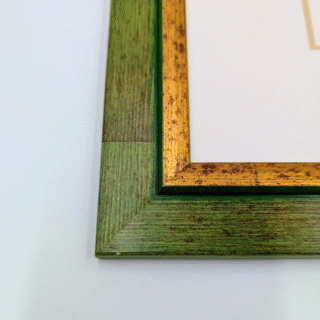 Framed cross-stitch artwork of a fairy in a yellow dress surrounded by blue and yellow flowers on a light background.