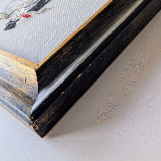 Framed cross-stitch artwork of a bride and groom dancing together in a stylized wedding tango, with black, white, and red accents.