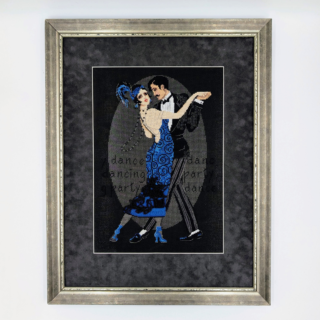 Framed cross-stitch artwork showing an elegant couple dancing tango on a dark background, with the woman in a blue dress and the man in a black suit.