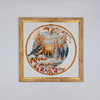 Stitched and framed embroidery artwork showing a small bird perched in a snowy winter landscape framed by autumn leaves in a circular composition.
